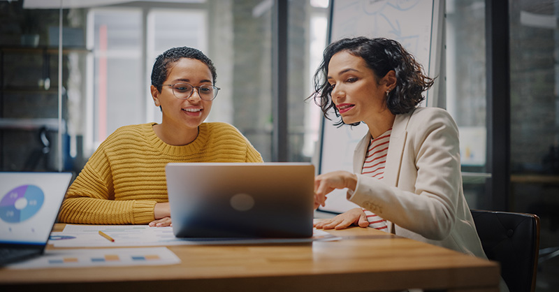 Two women discussing Legacy investments, Organizational adaptability and Future technology strategy