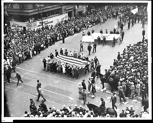 Workers carrying a large american flag