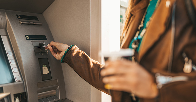 Woman inserting card at ATM