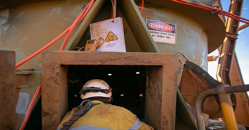 Construction Worker Entering a Confined Space