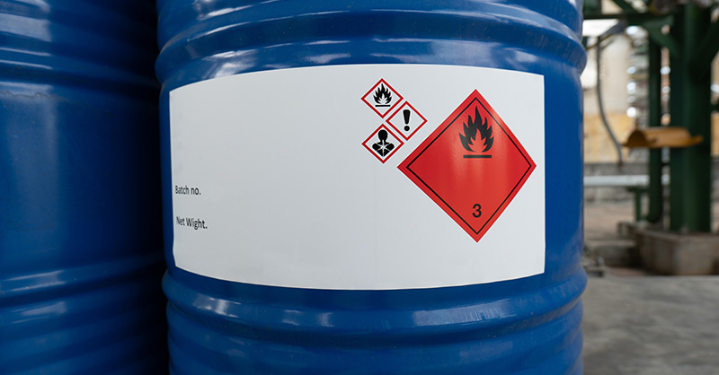 A barrel with a Flammable Liquid warning sticker on it.