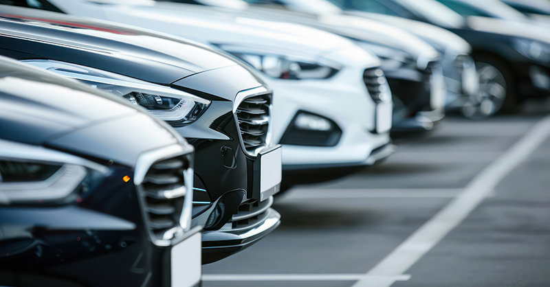 A row of cars in a parking lot.