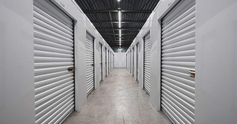 A self storage facility with multiple garages lining the walls.